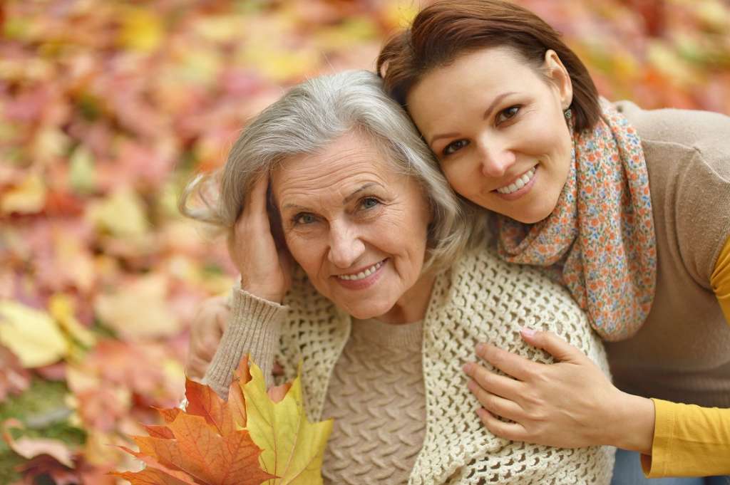 dementia-lady-enjoying-leaves-with-daughter